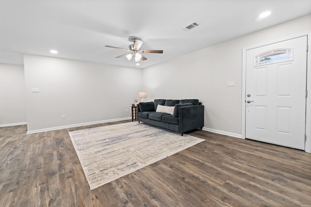 living area with dark wood-style flooring, recessed lighting, visible vents, a ceiling fan, and baseboards