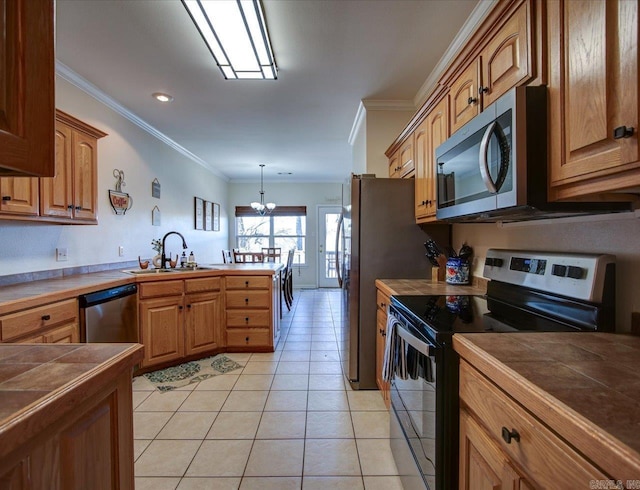 kitchen featuring tile countertops, appliances with stainless steel finishes, a sink, and ornamental molding