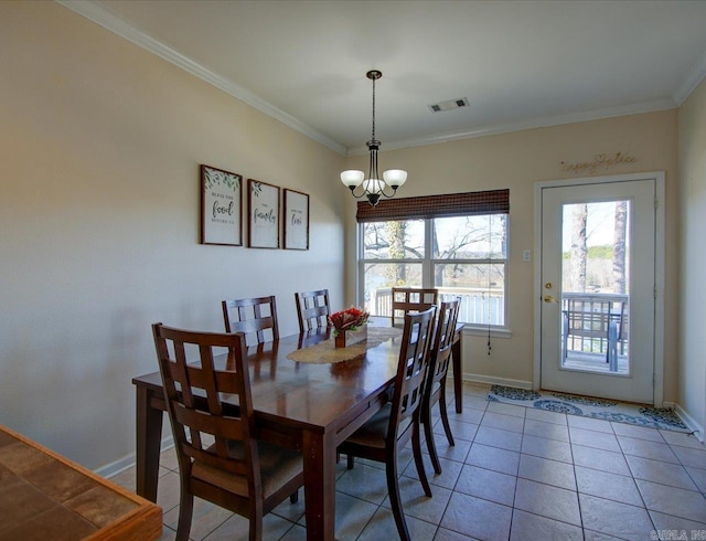 dining area featuring baseboards, ornamental molding, visible vents, and an inviting chandelier