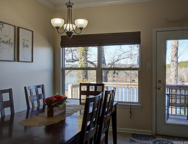 tiled dining room with baseboards, a chandelier, a wealth of natural light, and ornamental molding