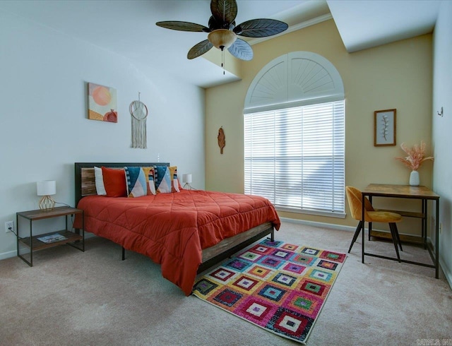 carpeted bedroom with a ceiling fan and baseboards