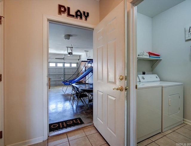 clothes washing area with laundry area, light tile patterned floors, baseboards, and separate washer and dryer