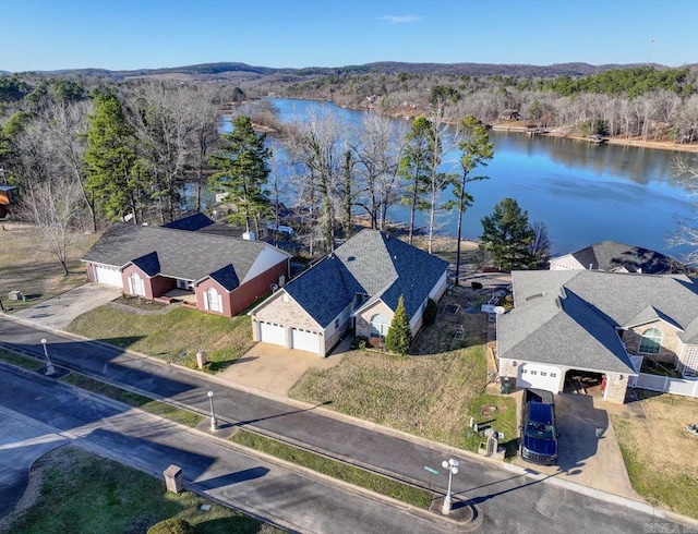 aerial view featuring a water view and a wooded view