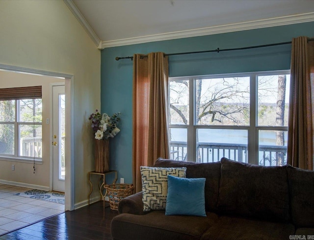 living room featuring baseboards, crown molding, and wood finished floors