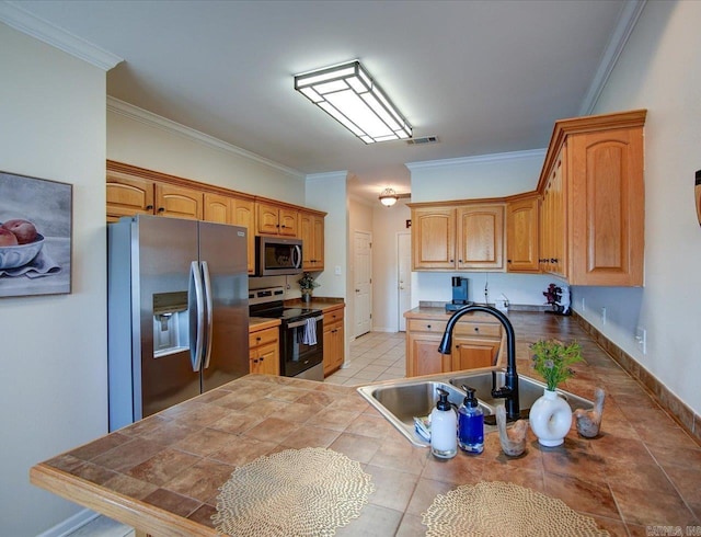 kitchen with tile countertops, a sink, visible vents, ornamental molding, and appliances with stainless steel finishes