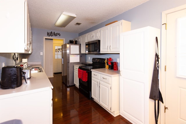 kitchen featuring light countertops, appliances with stainless steel finishes, and white cabinetry