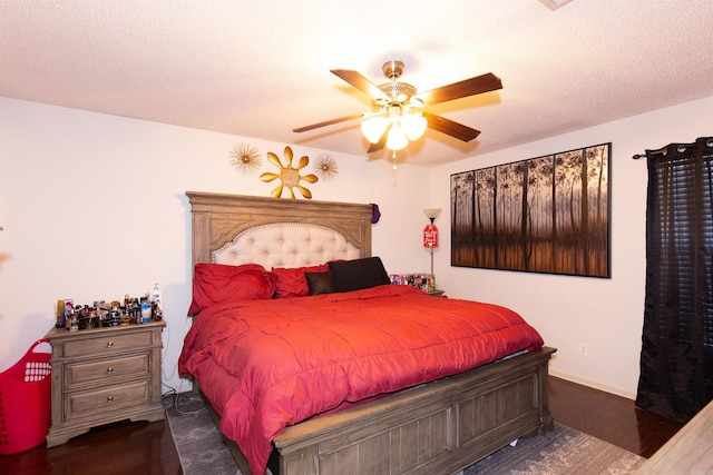 bedroom featuring baseboards, a textured ceiling, a ceiling fan, and wood finished floors