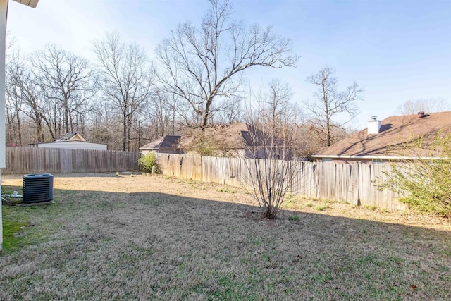 view of yard featuring central AC and a fenced backyard