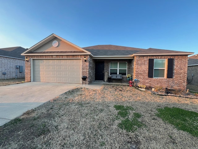 single story home featuring driveway, brick siding, an attached garage, and a shingled roof