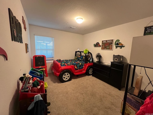 carpeted bedroom featuring a textured ceiling