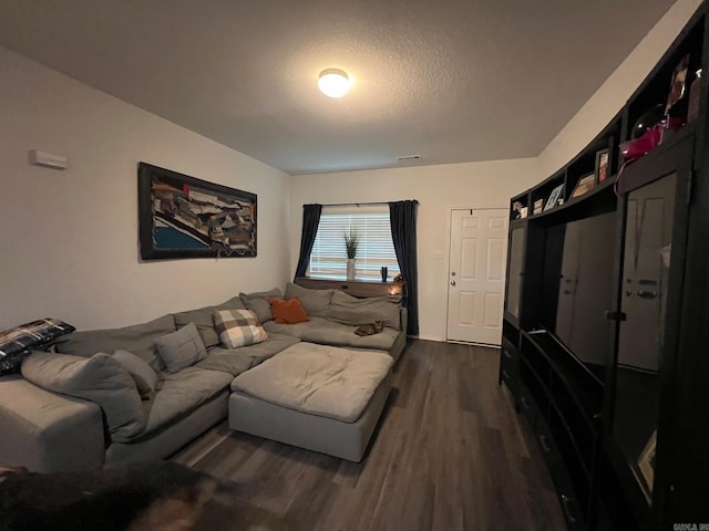 living room with visible vents and dark wood finished floors