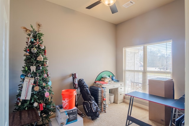 interior space with visible vents, ceiling fan, and baseboards