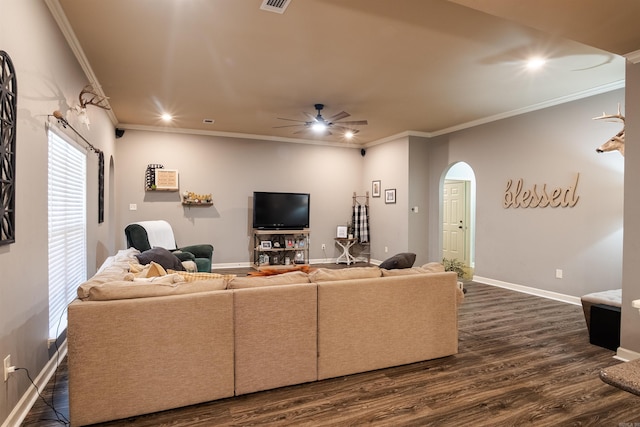 living room featuring arched walkways, ceiling fan, dark wood-style flooring, baseboards, and ornamental molding