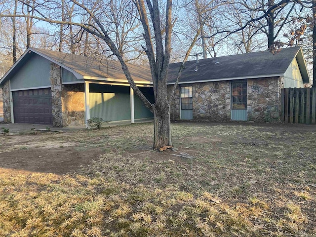 view of front of property featuring stone siding and fence