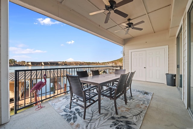 view of patio / terrace with a ceiling fan, outdoor dining area, a water view, and a balcony