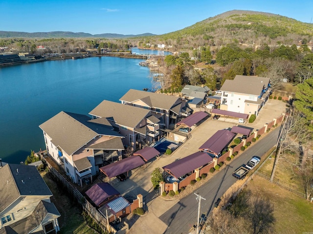 drone / aerial view featuring a residential view and a water and mountain view