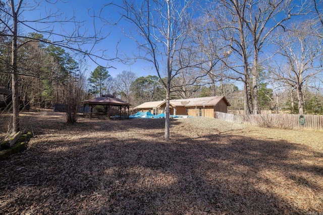 view of yard with fence and a gazebo