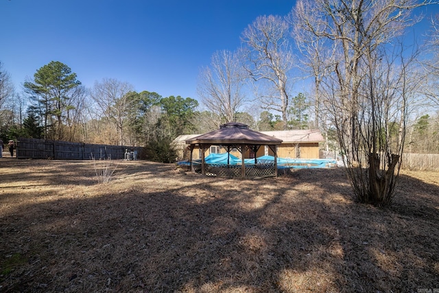 view of yard with fence and a gazebo