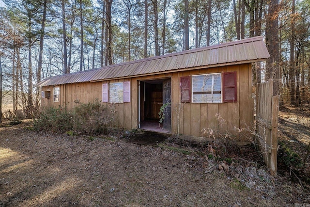 view of front of home featuring an outbuilding and metal roof