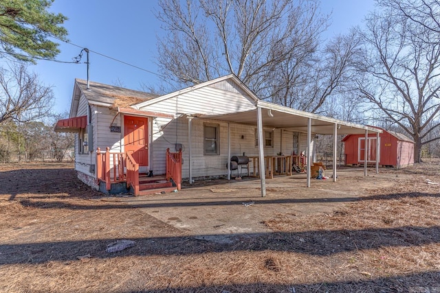 view of front of home with an outbuilding and a storage unit