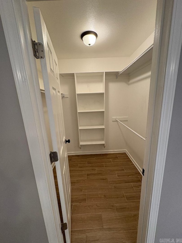 walk in closet featuring wood finish floors