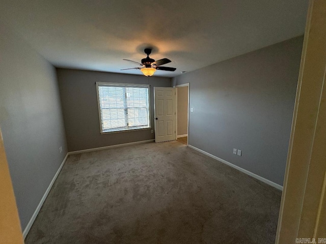 unfurnished bedroom with carpet, baseboards, and a ceiling fan