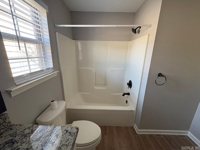 full bathroom featuring baseboards, toilet, and wood tiled floor