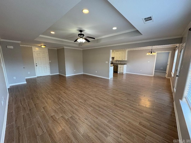 unfurnished living room featuring a ceiling fan, visible vents, a raised ceiling, and dark wood-type flooring