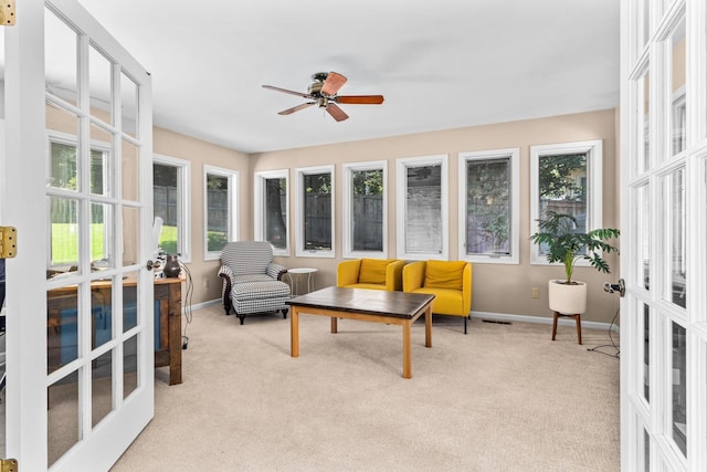 sunroom with visible vents, french doors, and a ceiling fan