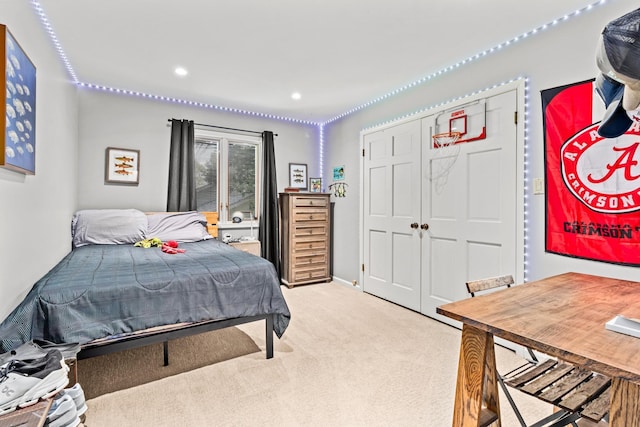 bedroom featuring recessed lighting, a closet, and light colored carpet