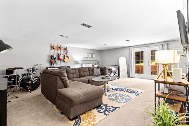 living room featuring visible vents, french doors, and light colored carpet