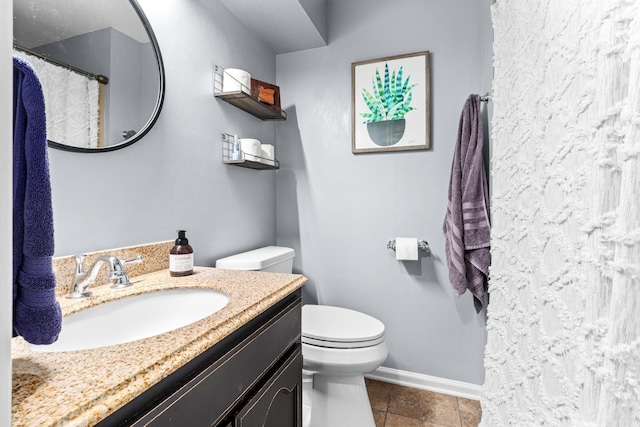 full bath featuring curtained shower, baseboards, vanity, and toilet