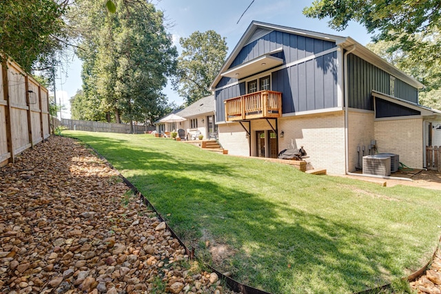 exterior space with a fenced backyard, a balcony, and central AC unit