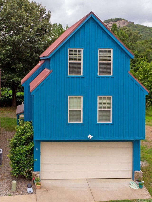 view of front facade featuring a garage and board and batten siding