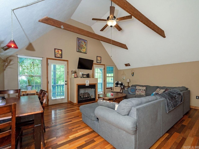 living room with ceiling fan, a fireplace, high vaulted ceiling, and wood finished floors