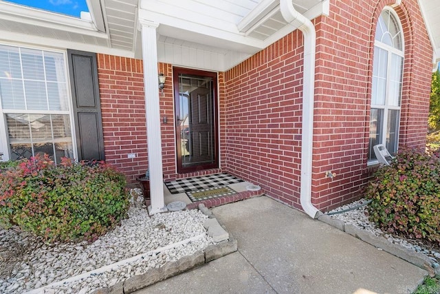 entrance to property featuring brick siding