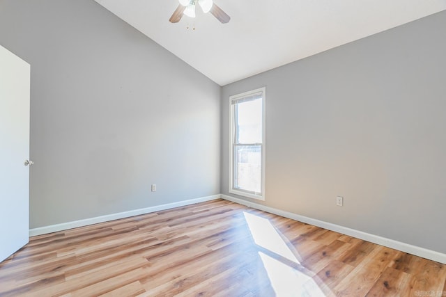 unfurnished room featuring lofted ceiling, ceiling fan, light wood-style flooring, and baseboards