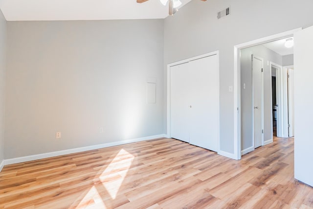 unfurnished bedroom featuring light wood-style floors, a closet, visible vents, and baseboards