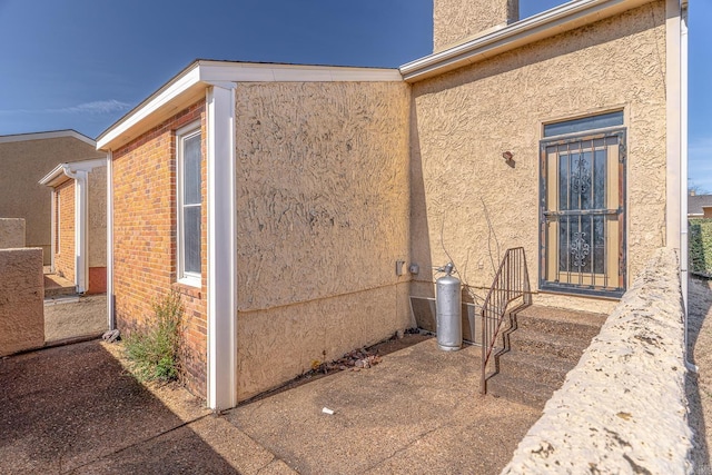 view of side of property with stucco siding