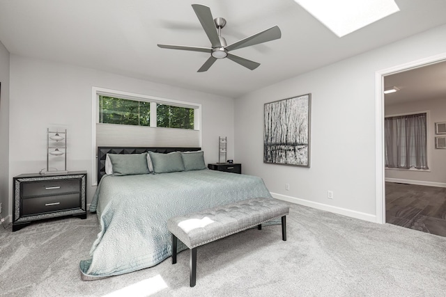 bedroom with carpet floors, connected bathroom, baseboards, and a ceiling fan