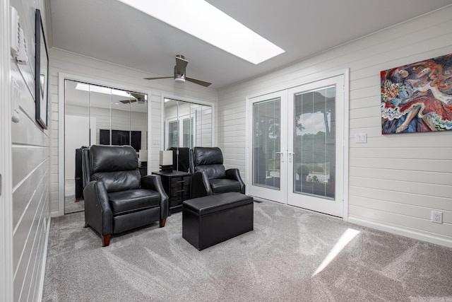 interior space with a ceiling fan, a skylight, and french doors