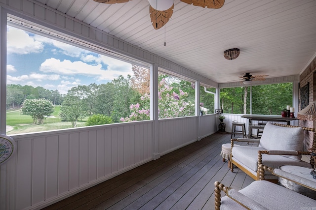 sunroom / solarium with a ceiling fan