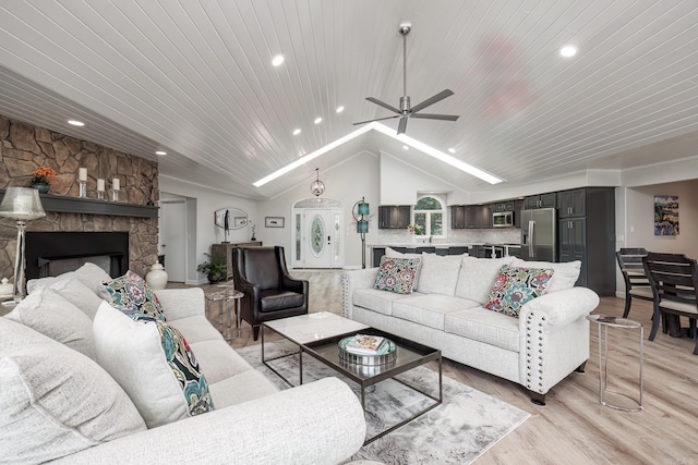 living area with light wood finished floors, lofted ceiling, wood ceiling, a fireplace, and recessed lighting