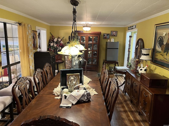 dining room featuring ornamental molding and wood finished floors