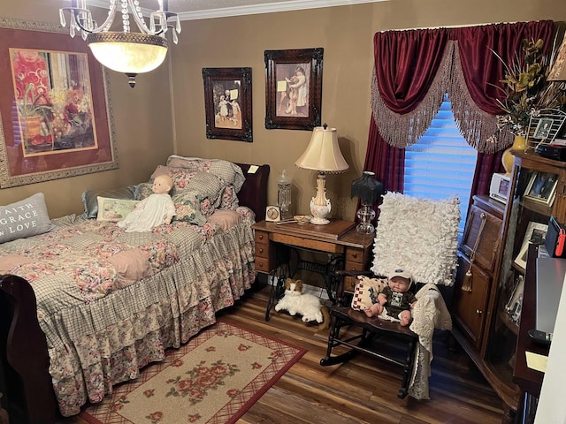 bedroom featuring an inviting chandelier, wood finished floors, and crown molding