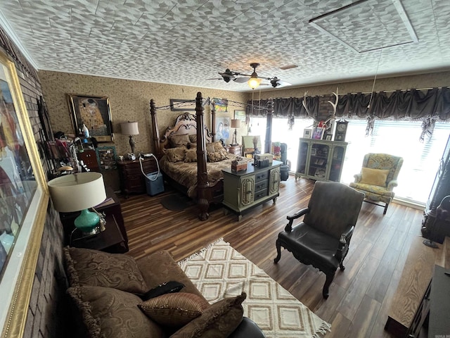 bedroom with attic access, wood finished floors, and wallpapered walls