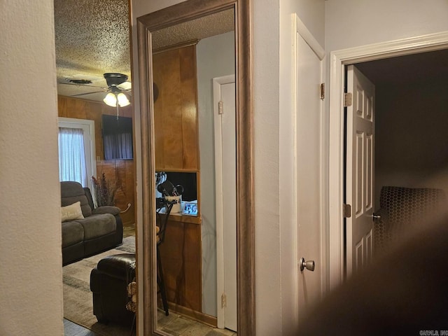 hallway featuring a textured ceiling