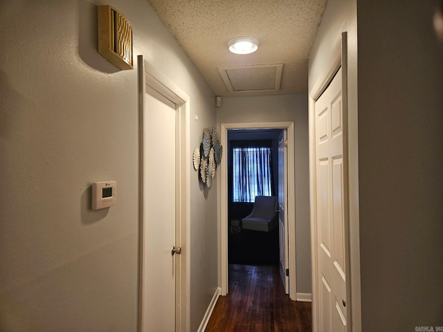 hall with dark wood finished floors and baseboards