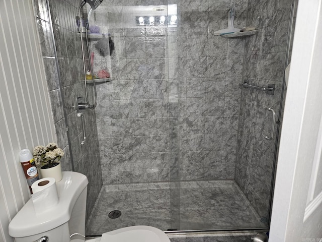 full bath featuring a stall shower and toilet