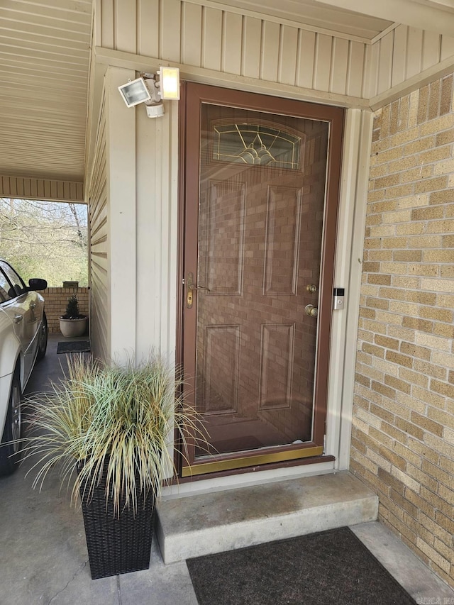 doorway to property with brick siding